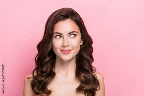 Photo of young pretty girl wonder dream interested look empty space pure collagen isolated over pink color background