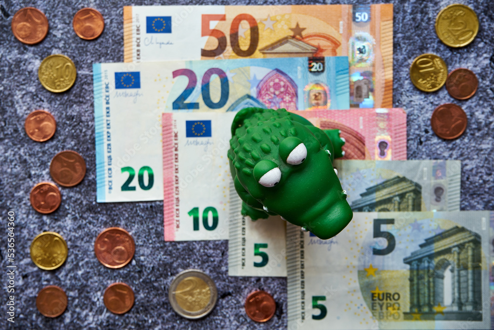 euro banknotes and a crocodile, predatory capitalism - obrazy, fototapety, plakaty 