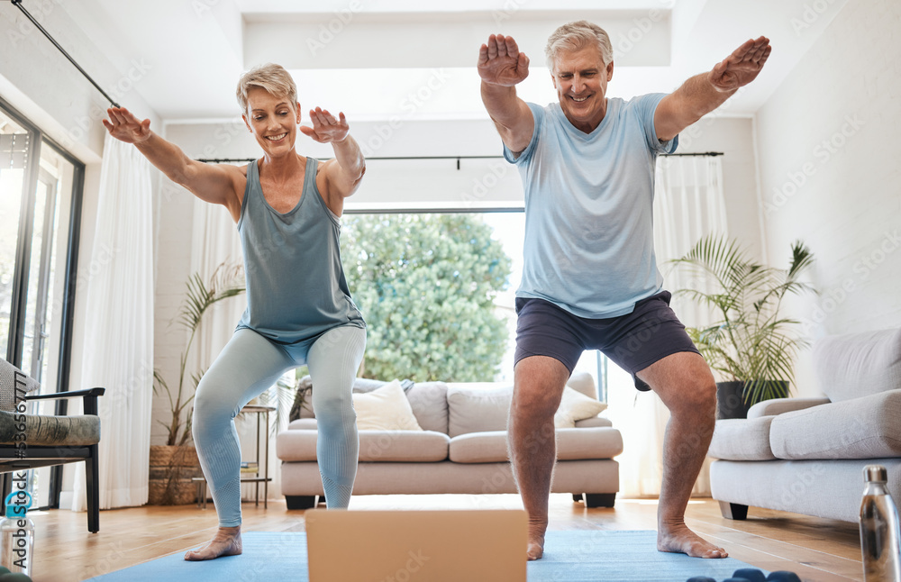 Elderly, couple and yoga in home with laptop for training with video online. Man, woman and retirement with computer for class on internet together in living room for health, wellness and fitness Elderly, couple and yoga in home with laptop for training with video online. Man, woman and retirement with computer for class on internet together in living room for health, wellness and fitness