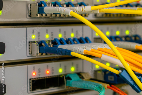 Fiber optic telecommunication cables are connected to the interfaces of the central router.