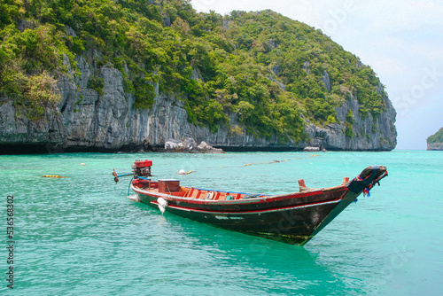 Panorama of thai traditional wooden longtail boat and beautiful sand beach in Krabi province. Traditional Thai boats near the beach. Thailand  © Anastasia