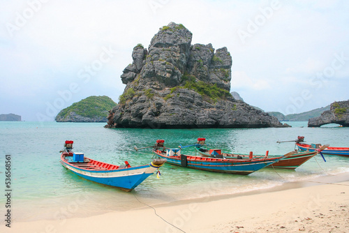 Panorama of thai traditional wooden longtail boat and beautiful sand beach in Krabi province. Traditional Thai boats near the beach. Thailand 