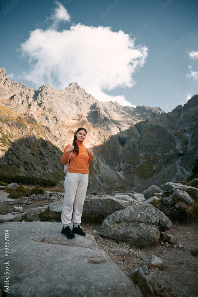 Girl in the mountains. A Caucasian woman is hiking. Concept of adventures in mountains.