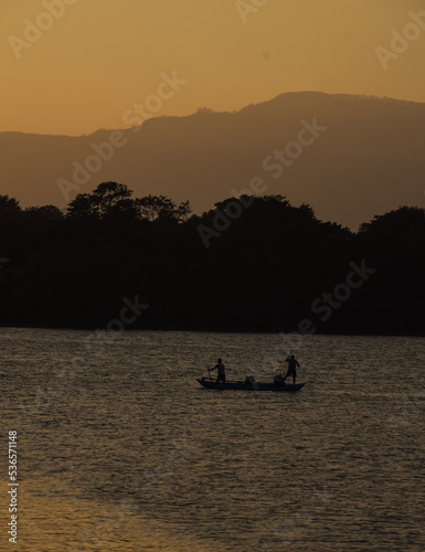 silhouette of a person in a boat