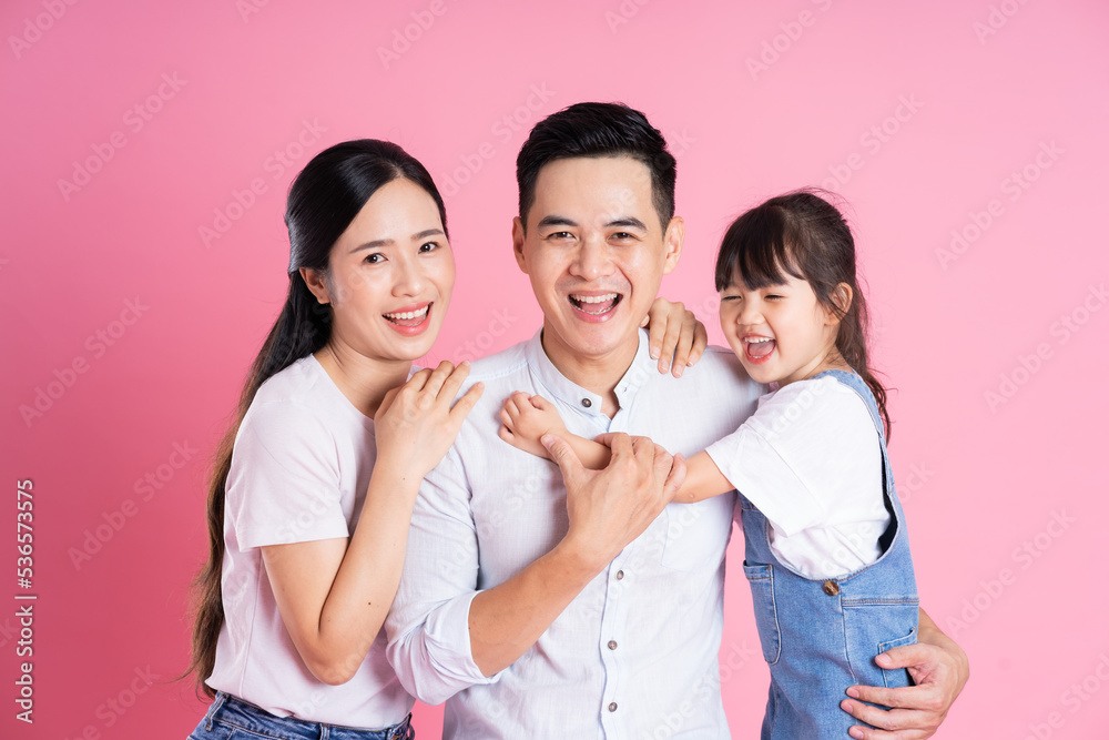 happy young asian family image, isolated on pink background happy young asian family image, isolated on pink background
