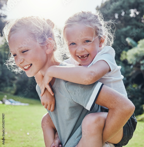 Happy, smile and siblings in an outdoor park during summer having fun and playing in nature. Happiness, excited and girl children on an adventure giving a piggy back ride outside in a green garden. photo