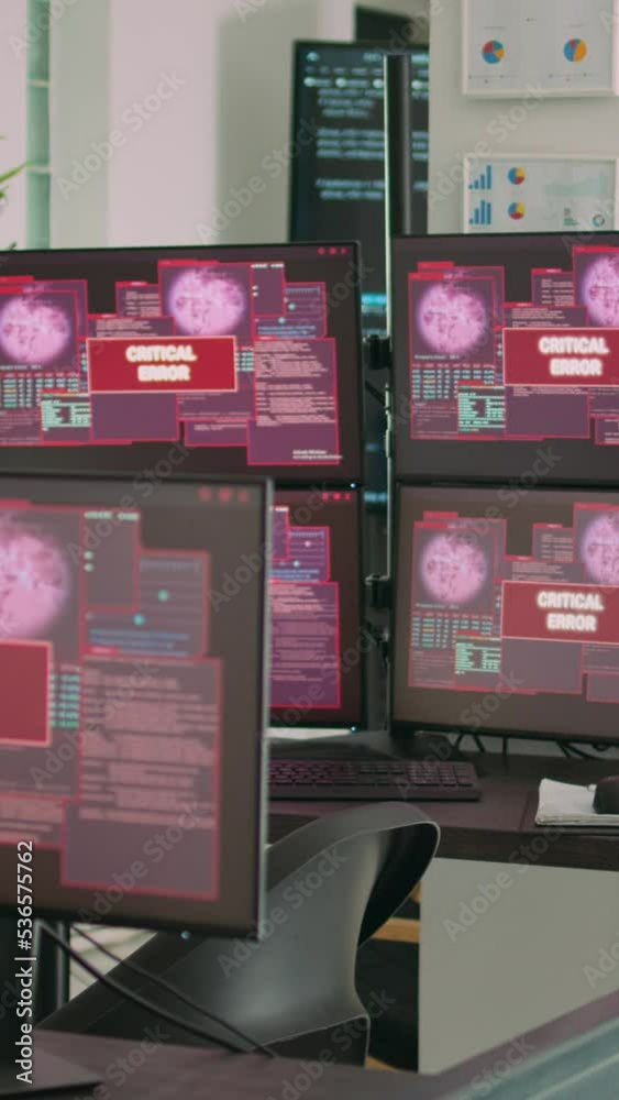 Vertical Computer Error Screen Vertical video: Desk with multiple monitors displaying error message on ...