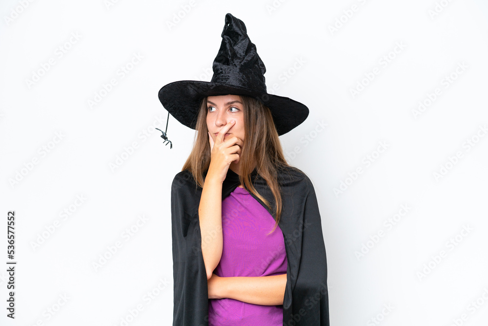 Young caucasian woman costume as witch isolated on white background having doubts and with confuse face expression Young caucasian woman costume as witch isolated on white background having doubts and with confuse face expression