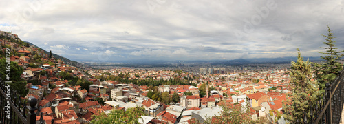 Panoramic view of Bursa city in Turkey. Bursa wide angle landscape with cloudy sky. Bursa is touristic destination and first capital of Ottoman Empire.