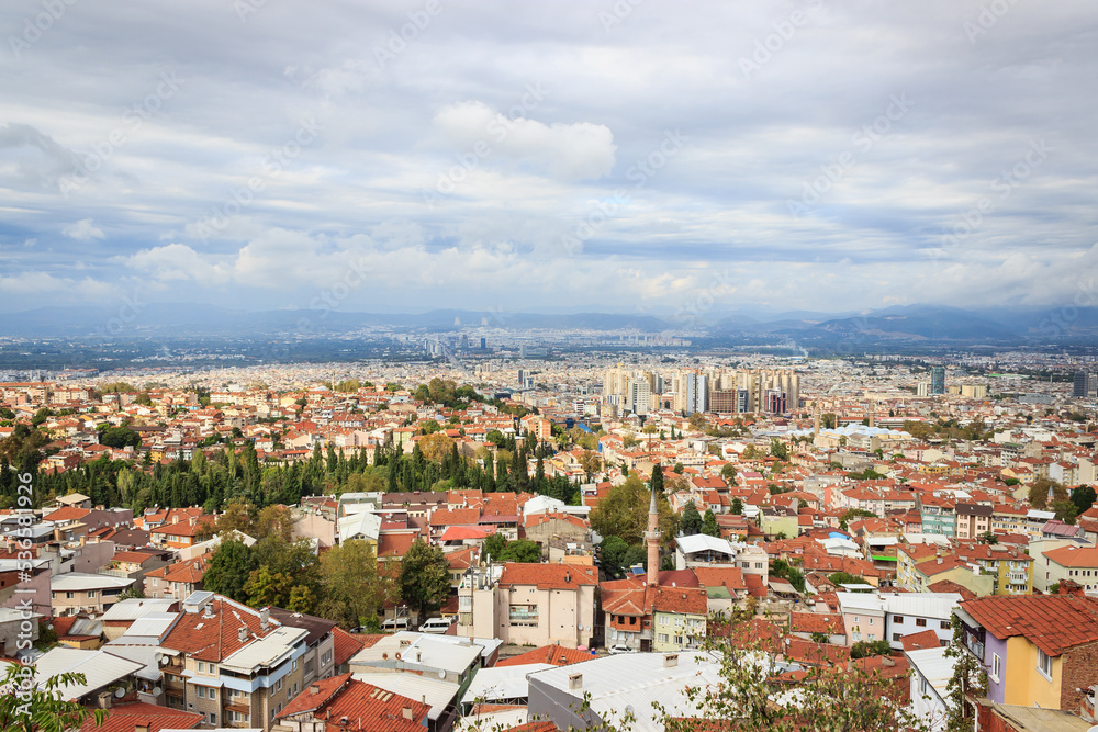 Historical Bursa city aerial view. Town landscape with cloudy sky. Bursa is touristic destination in Turkey.