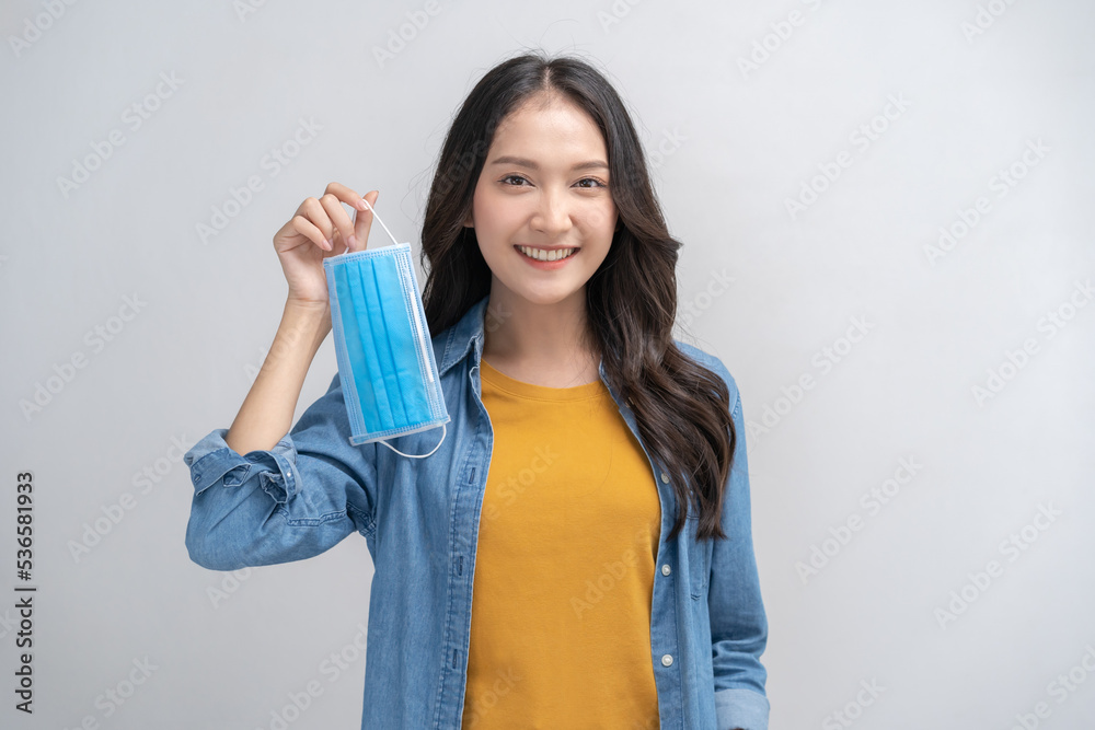 Portrait of cheer up asian young womon take off mask after getting anti virus vaccine covid-19 or pandemic, end country lockdown, unlock. Healthcare, immunity people isolated on white background. Portrait of cheer up asian young womon take off mask after getting anti virus vaccine covid-19 or pandemic, end country lockdown, unlock. Healthcare, immunity people isolated on white background.