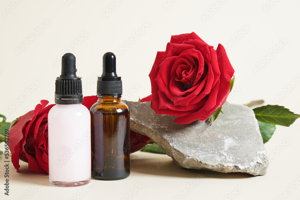 roses two different dropper bottles with serum and cosmetic oil. roses two different dropper bottles with serum and cosmetic oil.