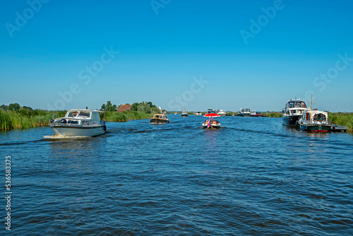 Cruising on frisian canals on a beautiful summer day in the Netherlands photo