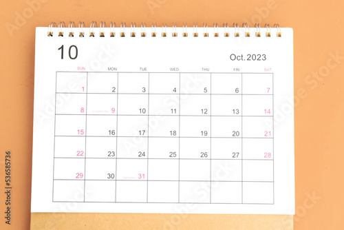 calendar October 2023 top view on orange a background