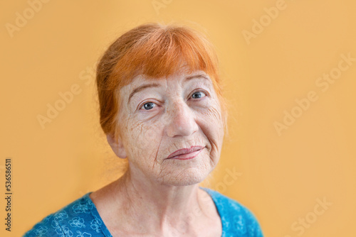 Fototapeta Portrait of a slightly sad, pensive older woman, the woman regrets that time fli