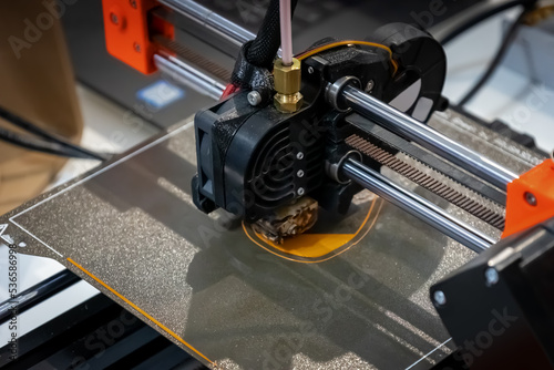 3D printer in operation. 3D printing of a geometric figure using ABS material, plastic polymers.