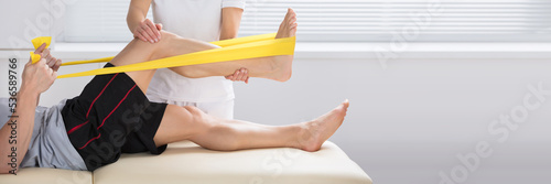 Принти на полотні Physiotherapist Giving Treatment With Exercise Band