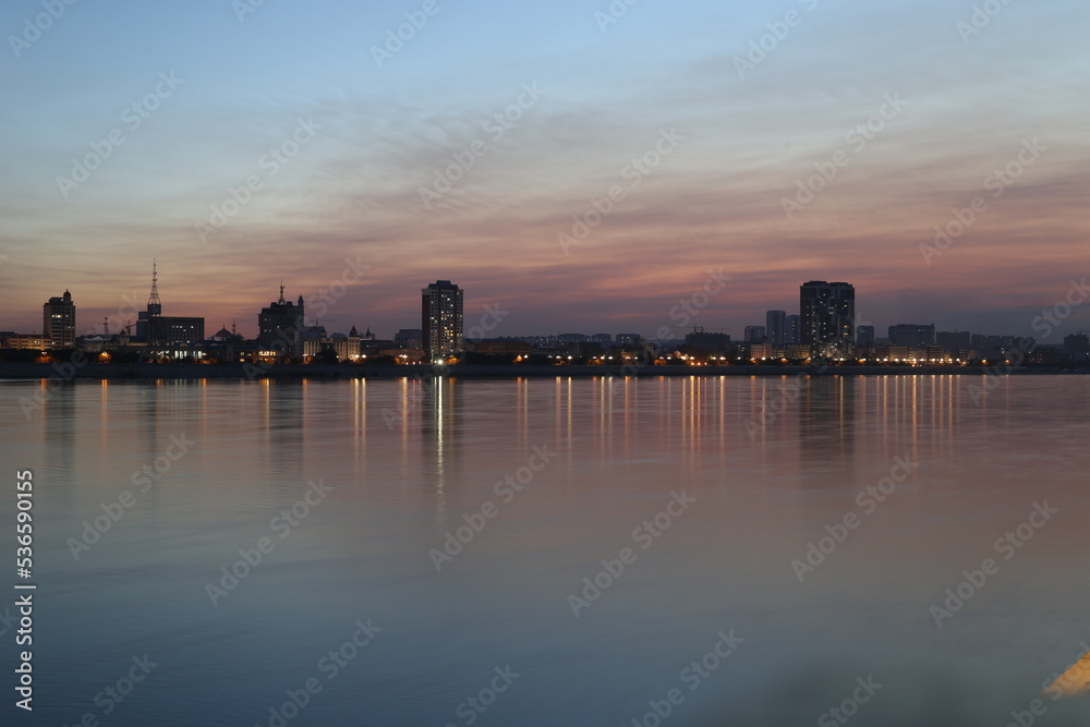 Blagoveshchensk, Russia: view of the Chinese city of Heihe from the embankment of the city of Blagoveshchensk. Lights of the night city in the reflection of the Amur river
