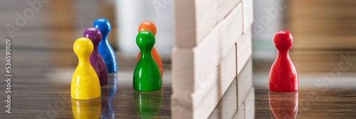 Red And Blue Figurine Paw Separated By Wooden Blocks