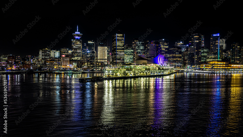 Naklejka premium Vancouver Canada night time evening skyline cityscape from the bay with reflections