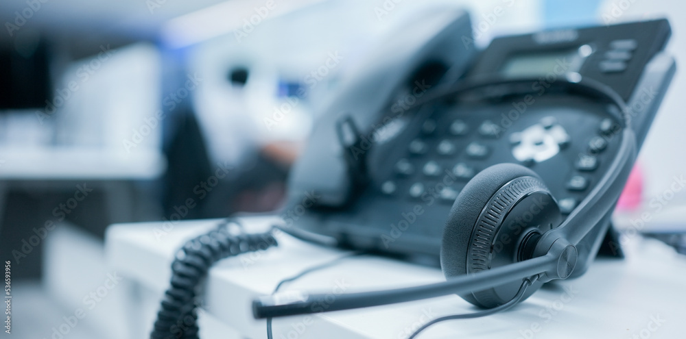 close up soft focus on headset with telephone devices at office desk for customer service support concept close up soft focus on headset with telephone devices at office desk for customer service support concept