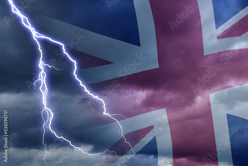 Dramatic stormy clouds with lightning next to UK flag. Upcoming crisis and economy problems in Britan. Huge inflation in economy in UK. photo