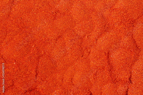 dry organic kashmiri red chili pepper powder texture background selective focus,well known for dark red color food recepi in indian gujarati food     photo