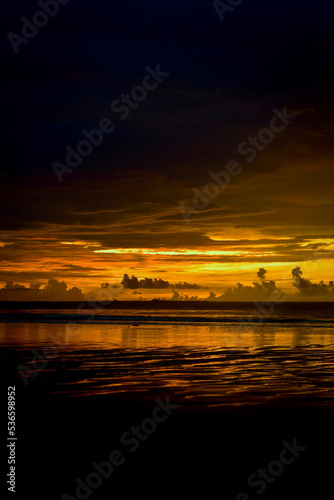 Magic view of sunset at Chaung Tha beach. Cloudy sky. Golden hour at seaside. photo