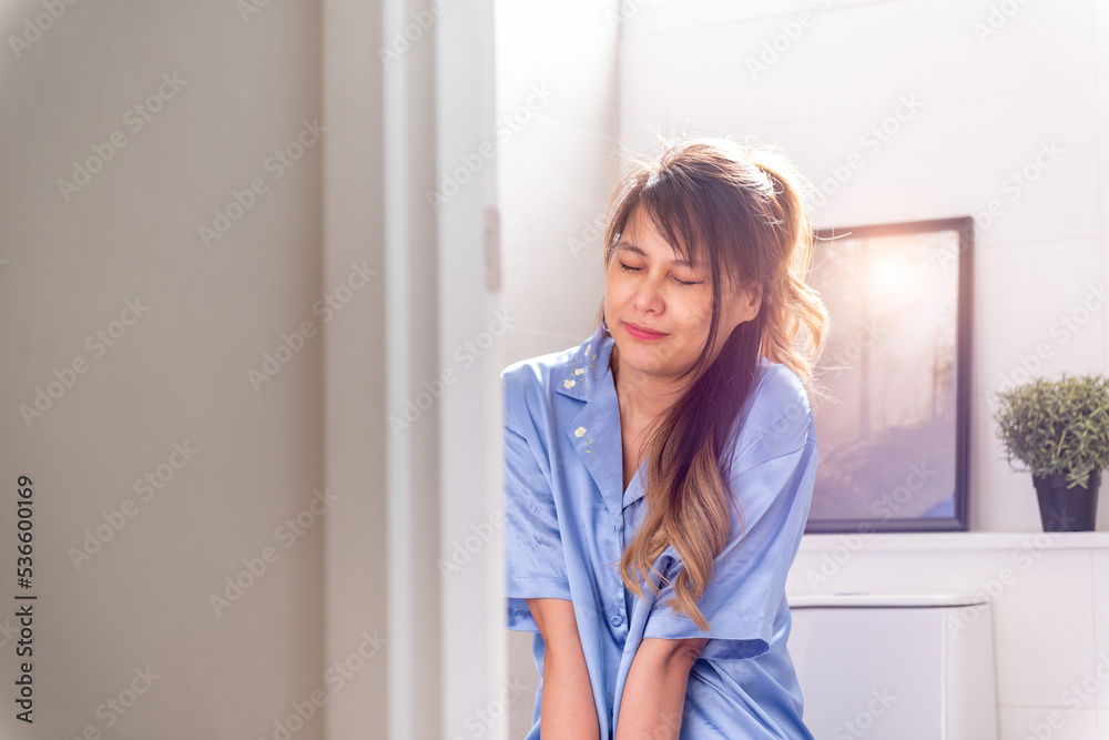 asian woman having stomach ache pain in toilet. female unhappy painful sick person sitting in toilet room having nasty diarrhea from poison. weak stressed beautiful uncomfortable woman have period asian woman having stomach ache pain in toilet. female unhappy painful sick person sitting in toilet room having nasty diarrhea from poison. weak stressed beautiful uncomfortable woman have period