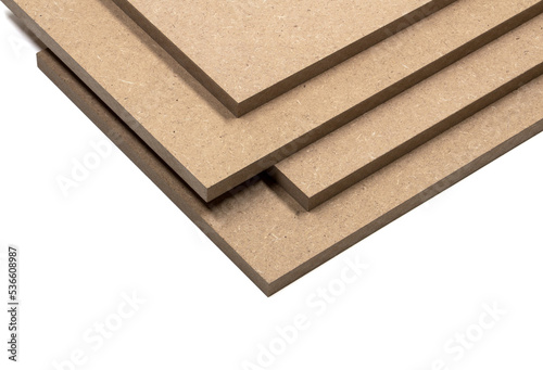 Four boards of raw mdf with clear and precise edges, arranged in a pile.