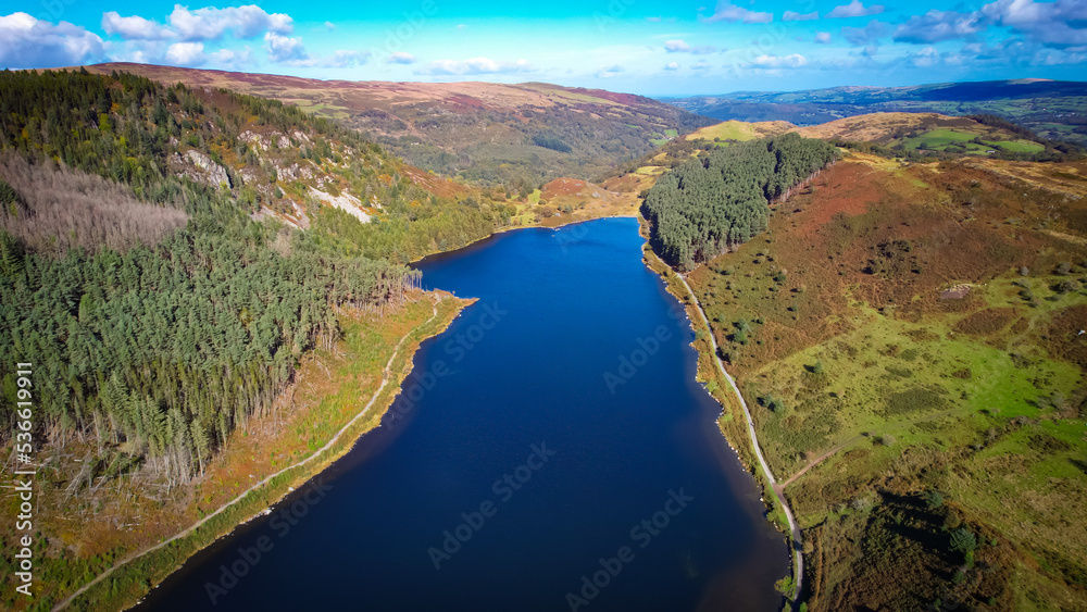 Fototapeta premium Llyn Geirionydd lies in a valley in North Wales where the northern edge of the Gwydyr Forest meets the lower slopes of the Carneddau mountains. The lake is almost a mile long and covers an area of 45 