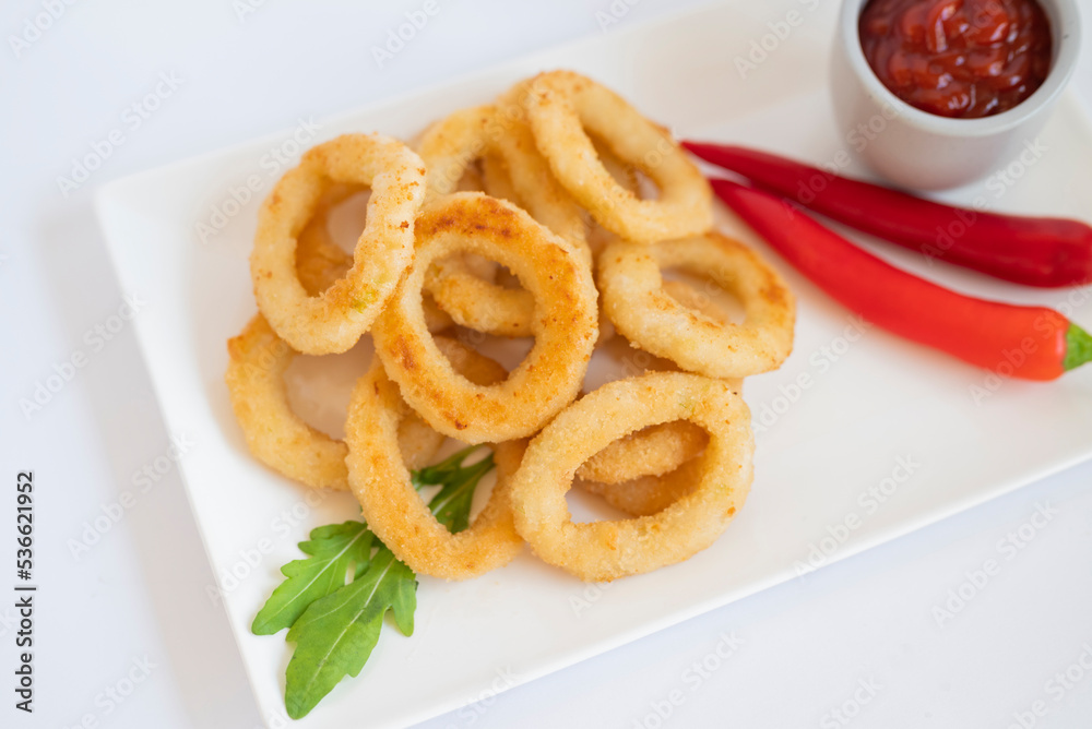 fast food breaded onion rings fried with sauce on a plate fast food breaded onion rings fried with sauce on a plate