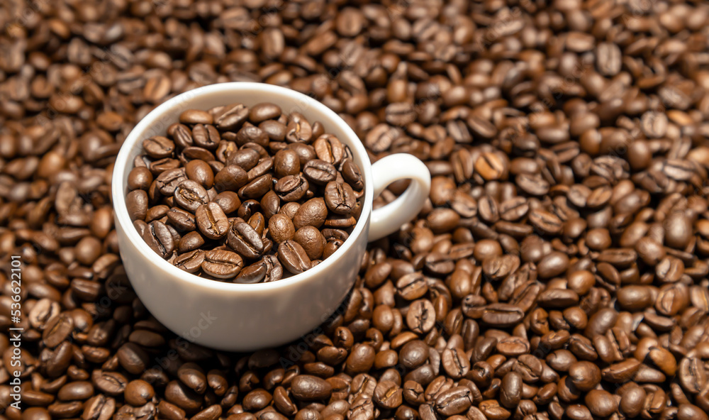 Texture of coffee beans. Food background of coffee beans. A cup of coffee full of coffee beans. Texture of coffee beans. Food background of coffee beans. A cup of coffee full of coffee beans.