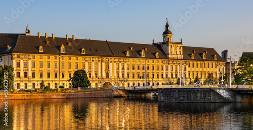 Historic old town quarter with Wroclaw University and Grodzka street embankment at sunset over Warta River in Wroclaw in Poland