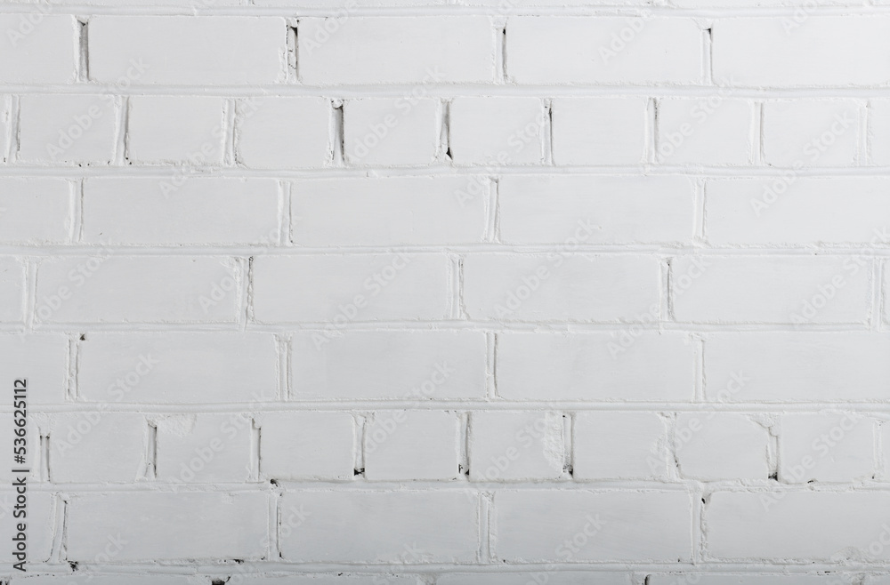 Fototapeta premium Old rough white painted brick wall large texture. Whitewashed brickwork masonry backdrop. Light grunge abstract background