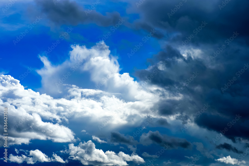 Obraz premium Beautiful dramatic sky with white and dark blue storm clouds, contrast sky