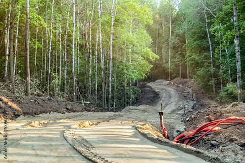 Laying a new winding road through a forest ravine.