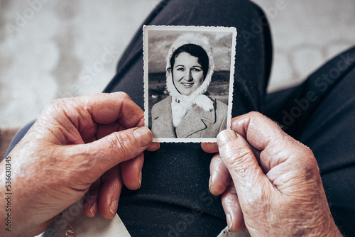 CIRCA 1970: Elderly woman hands holding vintage, black and white photo