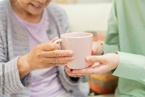 自宅 一緒にお茶を飲む祖母と孫 photo