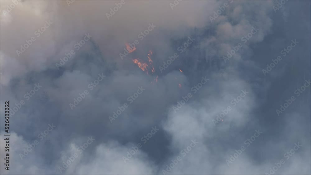 BC Forest Fire and Smoke over the mountain near Hope during a hot sunny summer day. British Columbia, Canada. Wildfire natural disaster. Slow Motion BC Forest Fire and Smoke over the mountain near Hope during a hot sunny summer day. British Columbia, Canada. Wildfire natural disaster. Slow Motion