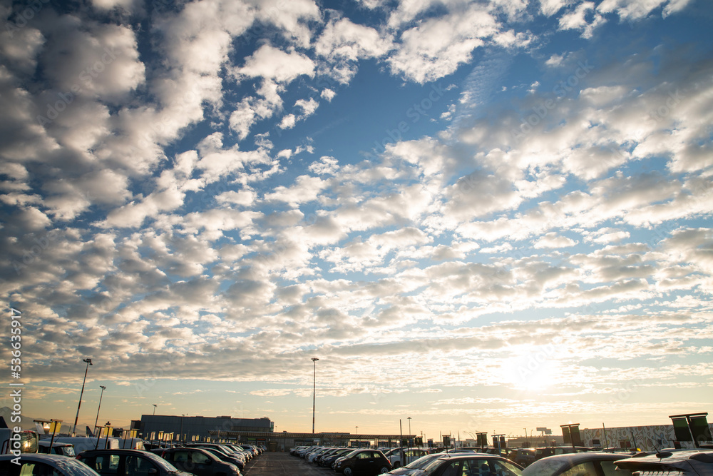 Fantastic winter shiny sky in the north of Italy at Bergamo airport and a little - the roofs of cars that are rented
