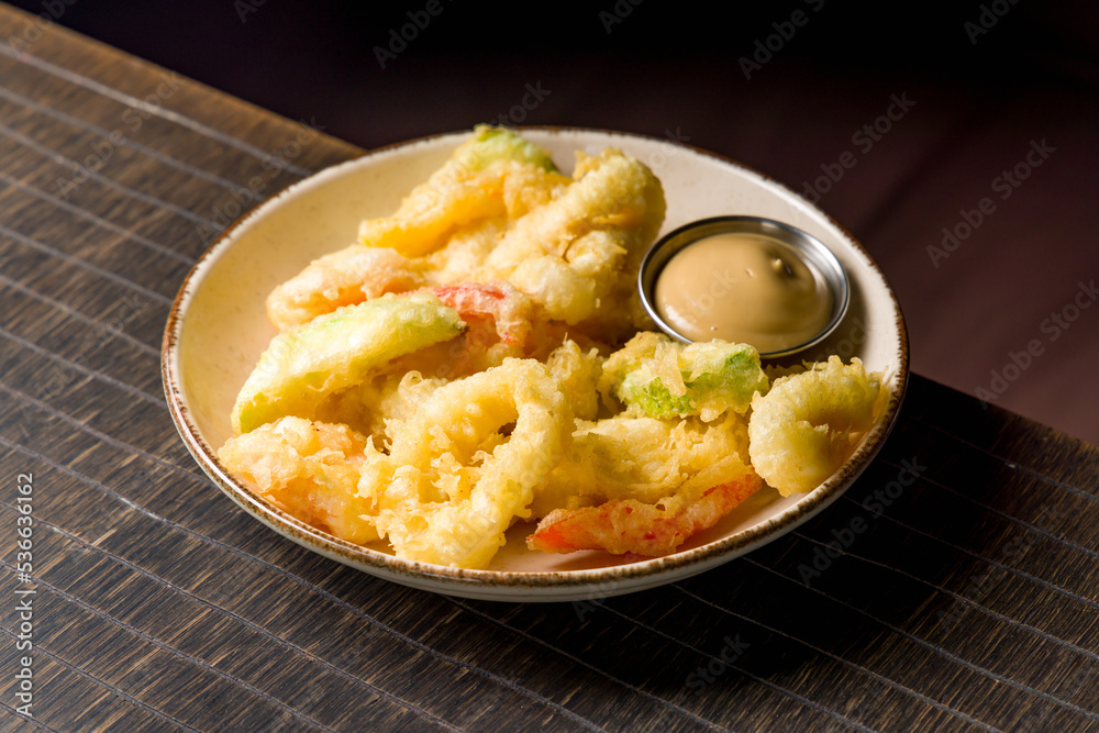 fritto misto with sauce on white plate, deep-fried vegetables