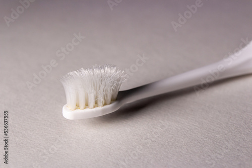 Closeup old toothbrush on white background. Toothbrush s bristles are worn out.