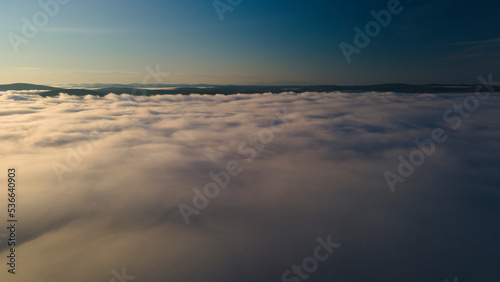 Early Sunrise and Horizon over the clouds cover mountains ridge © Alex