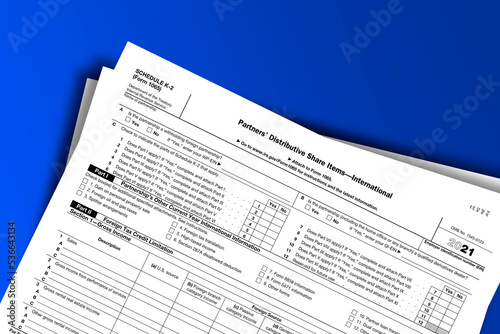 Form 1065 (Schedule K-2) documentation published IRS USA 44478. American tax document on colored photo