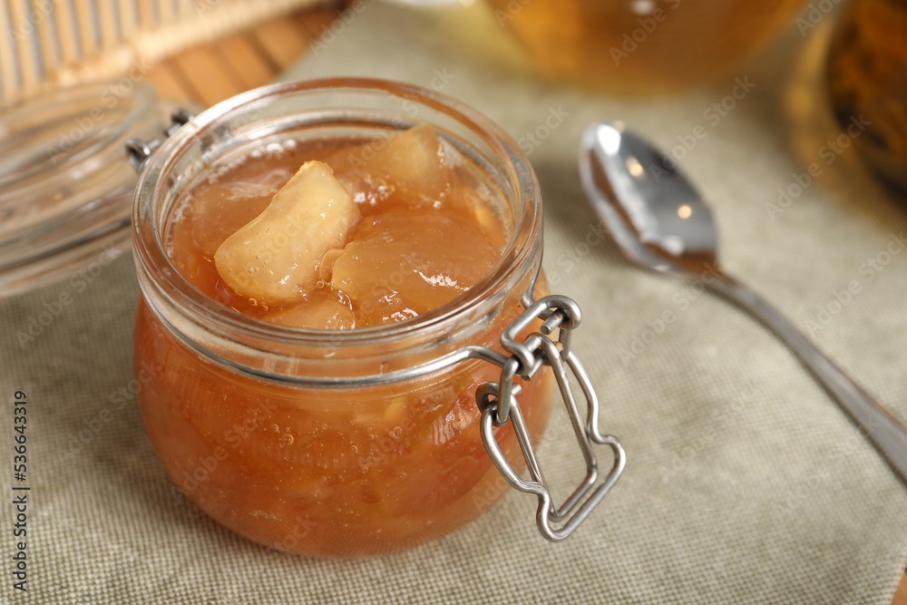 Delicious apple jam in jar on table, closeup Delicious apple jam in jar on table, closeup