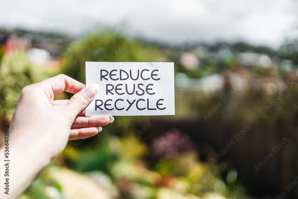 sustainability and circular economy, reduce reuse recycle sign in front ...