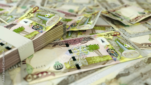 close up of Iraqi dinar notes spread on table. 3d rendering of money scattered on surface