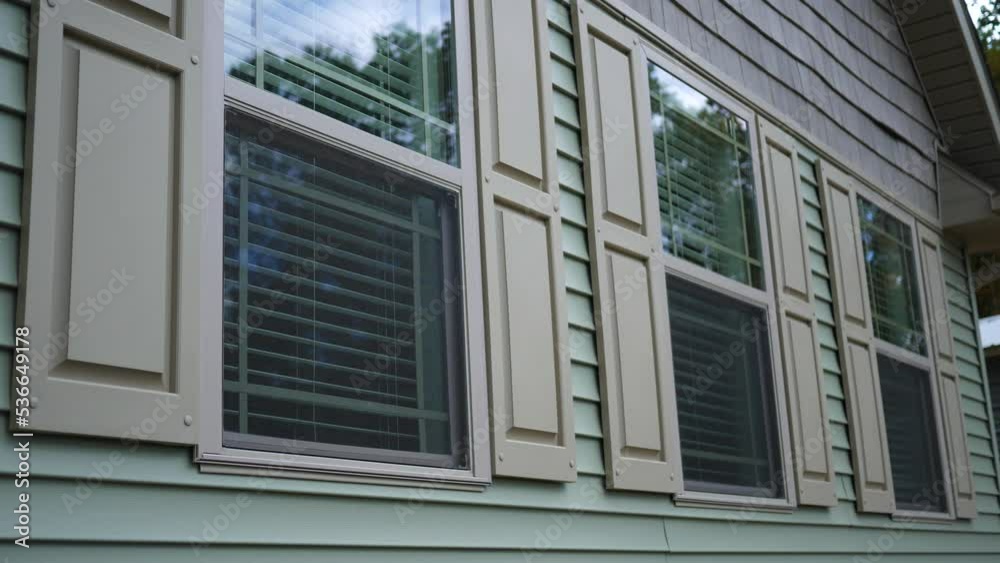 Three windows of modern luxury home as seen from outside Three windows of modern luxury home as seen from outside