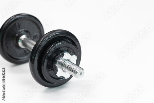 steel dumbbell on white background, close up, copy space, fitness, weight training 